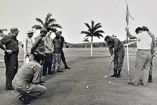 'Che' Guevara (crouching) looks on as Fidel Castro attempts a short putt