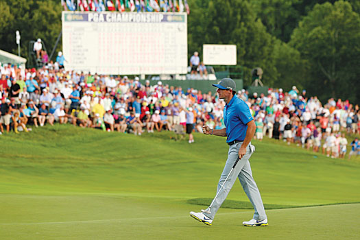 Rory McIlroy celebrates holing the winning putt