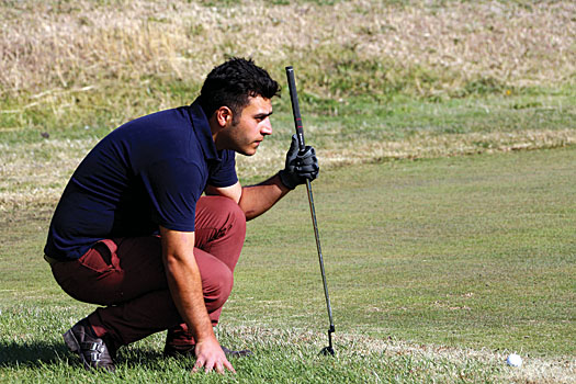 A player at Engelhab lines up his putt