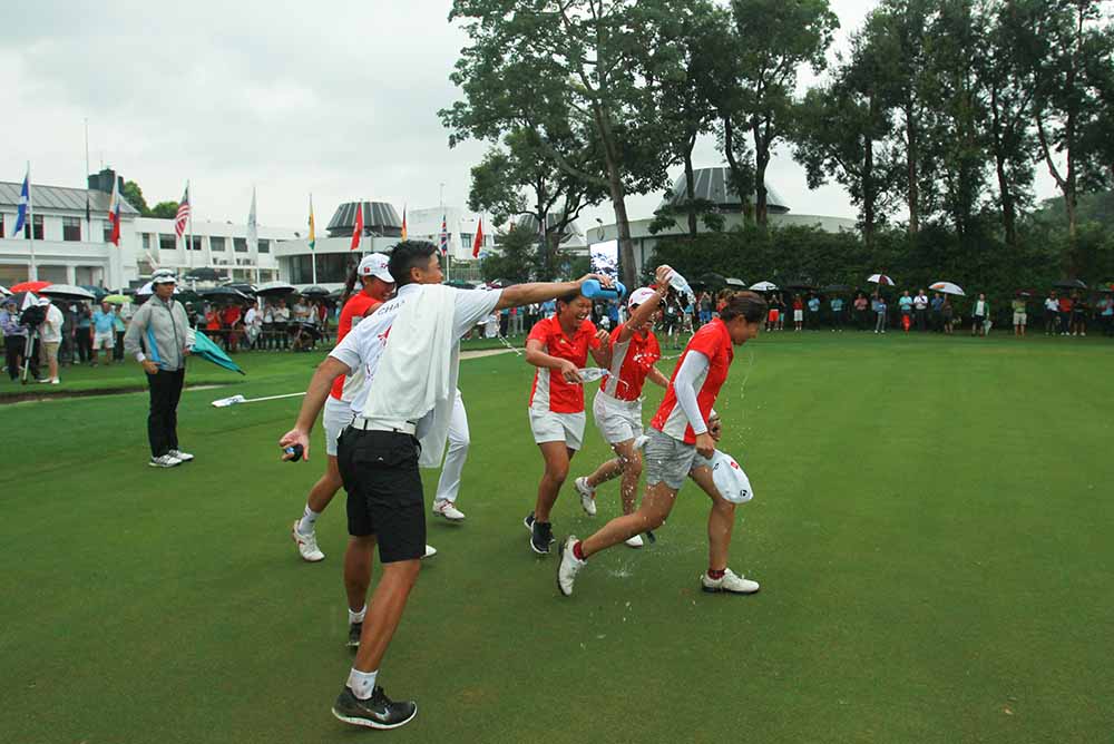 Tiffany gets a soaking from her Hong Kong international teammates after sinking the winning putt