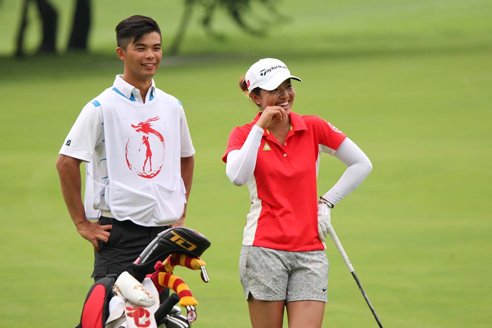 Sharing a laugh with her caddie Steven Lam