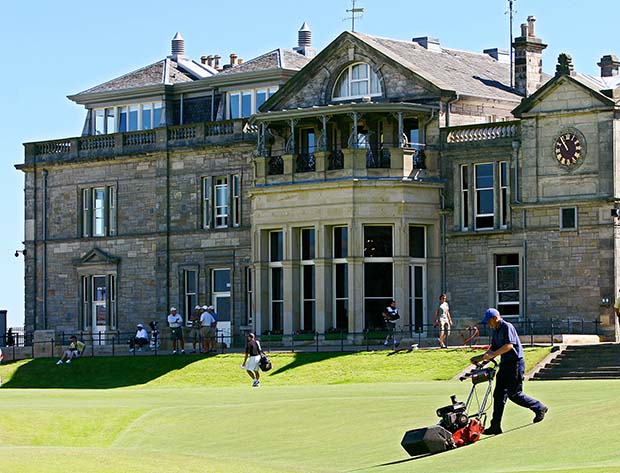 A groundsman mows grass in front of the club house on the Old Course during a practice round ahead of The Open Championship in St Andrews
