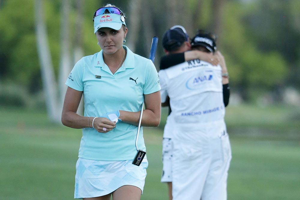 Lexi Thompson walks off the 18th green, as Korean So Yeon Ryu celebrates