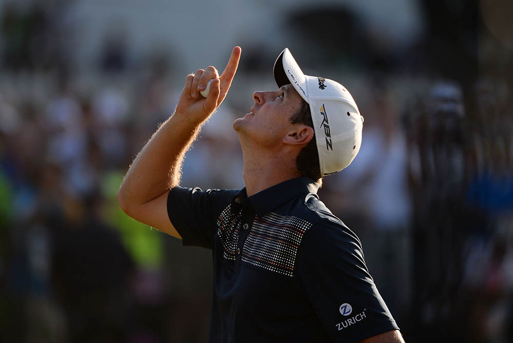Justin Rose looks to the heavens in acknowledgement of his deceased father after putting on the 18th hole to win the U.S. Open in 2013