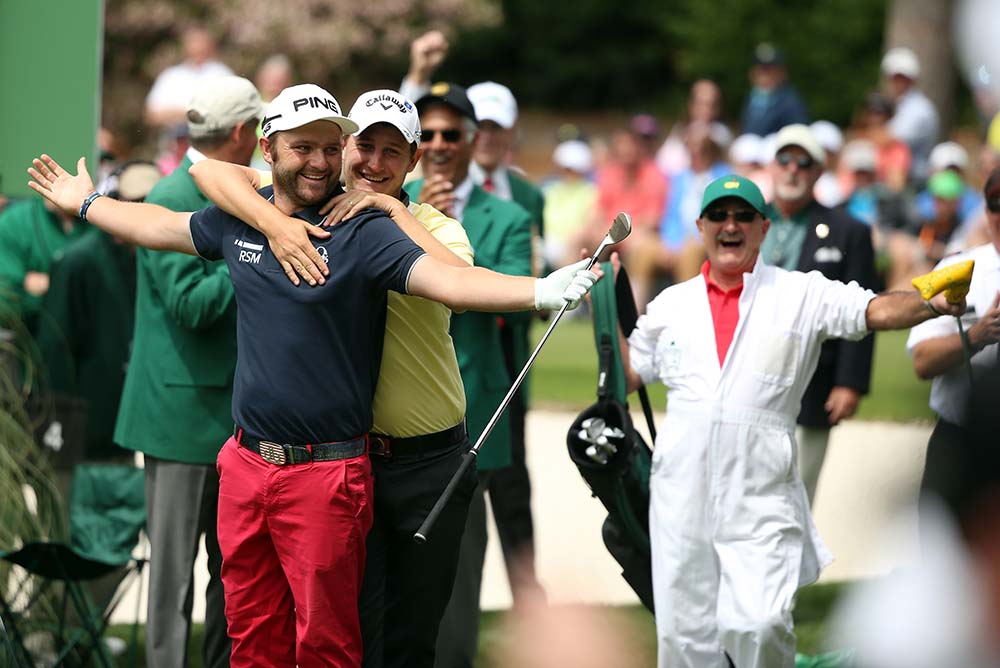 Andy Sullivan celebrates with Emiliano Grillo after hitting a hole in one on the 4th hole during the Par 3 Contest before the start of the 2016 Masters