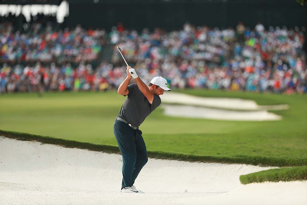 Francesco Molinari hits out of the bunker on the 18th