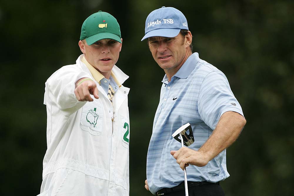 Faldo chats with his caddie Ryan Shaw on the first green during the 2005 Masters