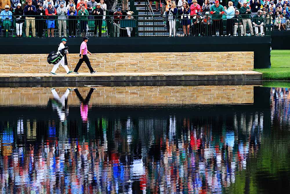 Patrick Reed and caddie Kessler Karain cross the Sarazen Bridge