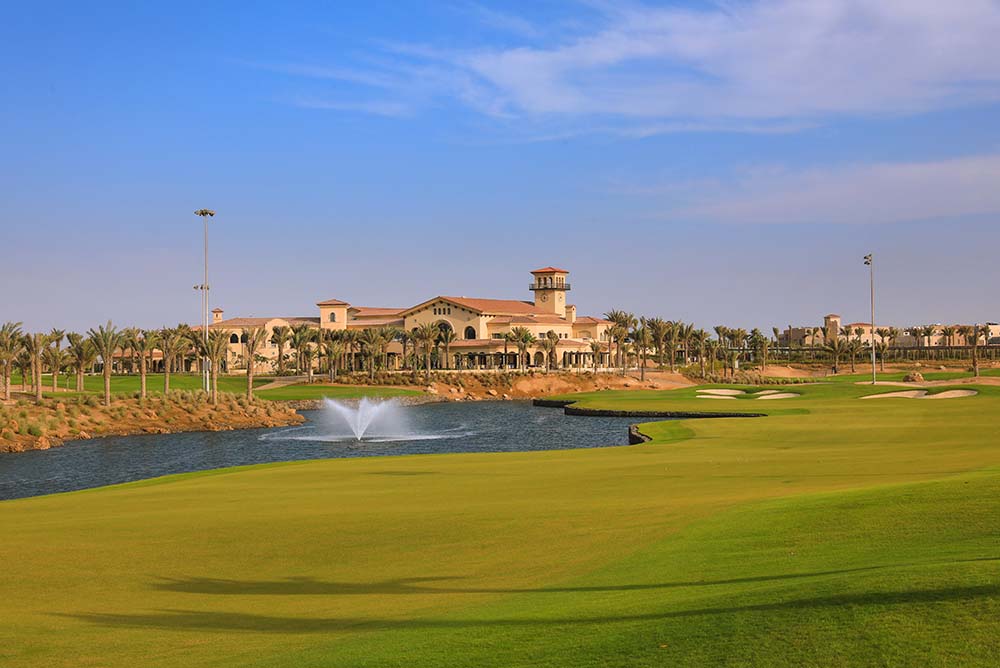 The 18th hole of Royal Greens Golf and Country Club with a view of the clubhouse