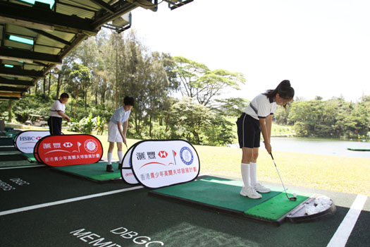 Students enjoy hitting balls from the club's lakeside driving range