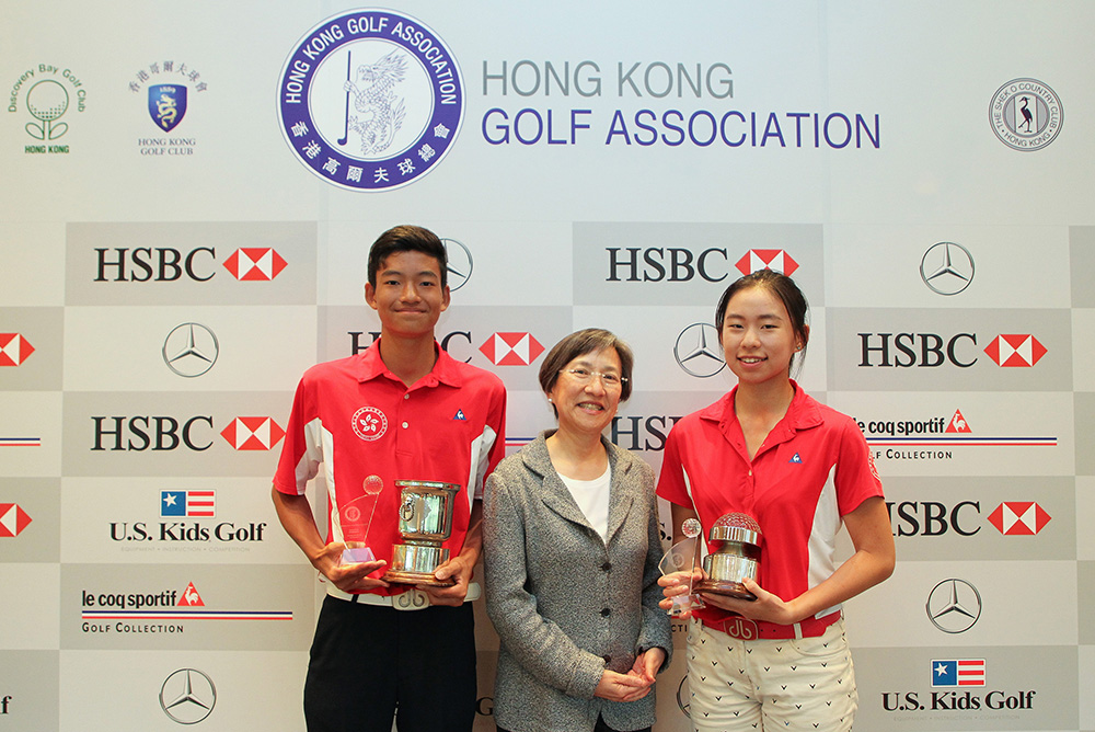 Taichi Kho and Virginie Ding receive their Hong Kong Junior Close Championship trophies from Sue Sue Tong, Clubhouse Manager of the Hong Kong Golf Club 